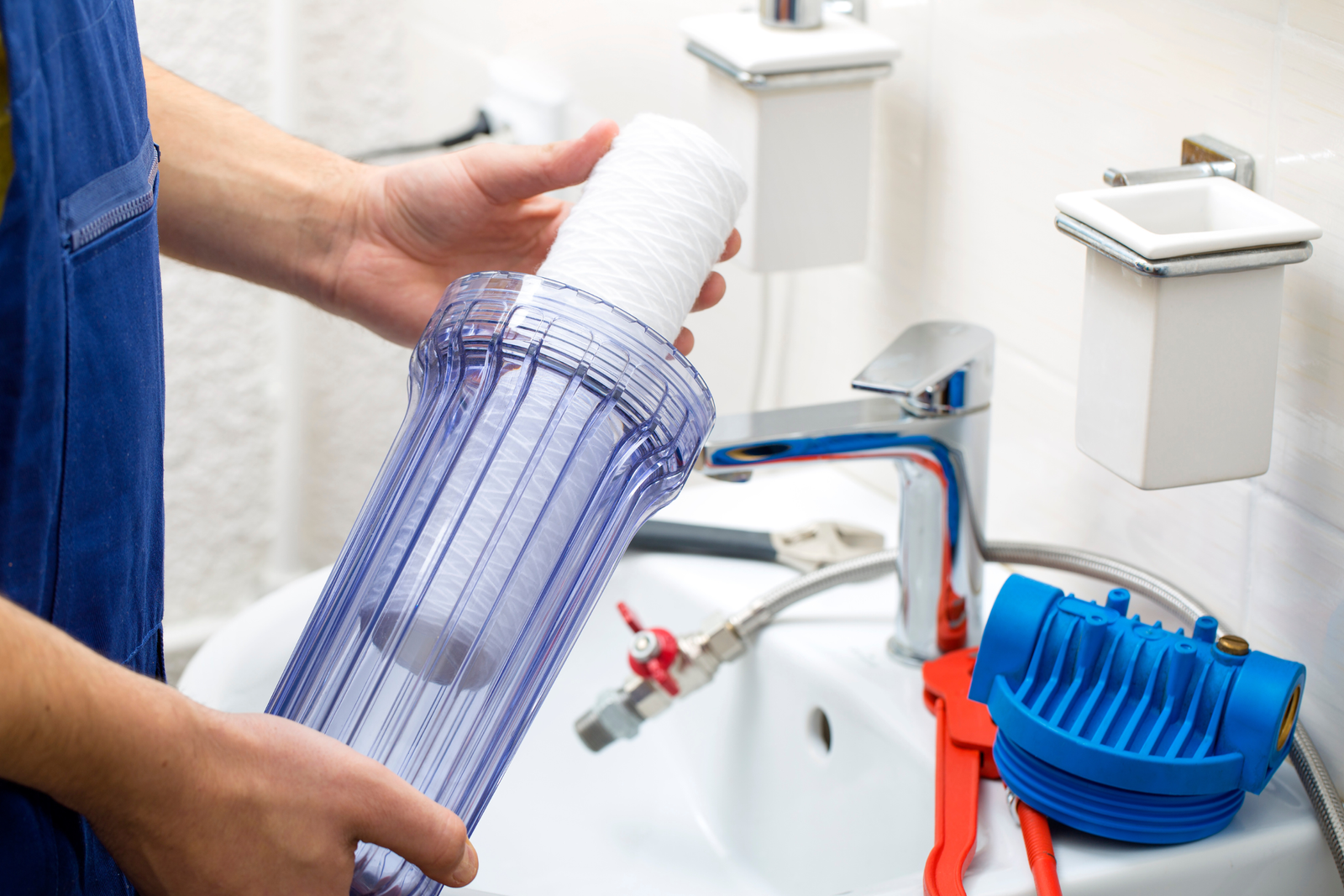 Plumber installing water filter